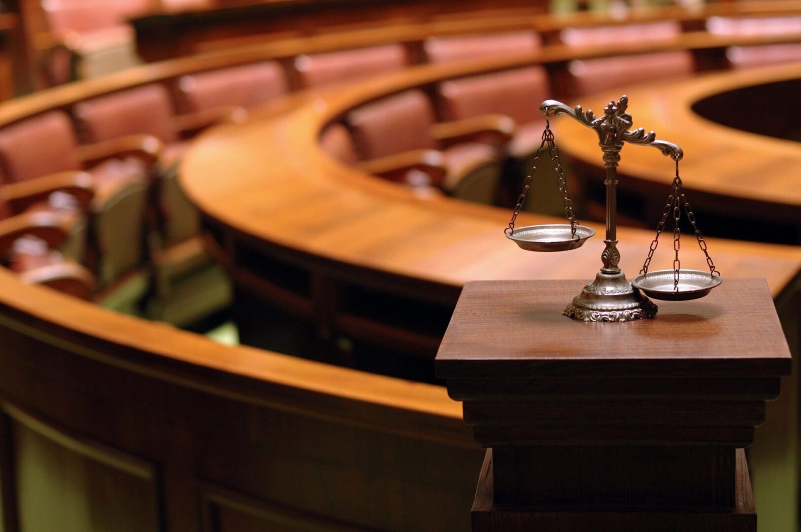 A wooden table with a statue of justice on it.